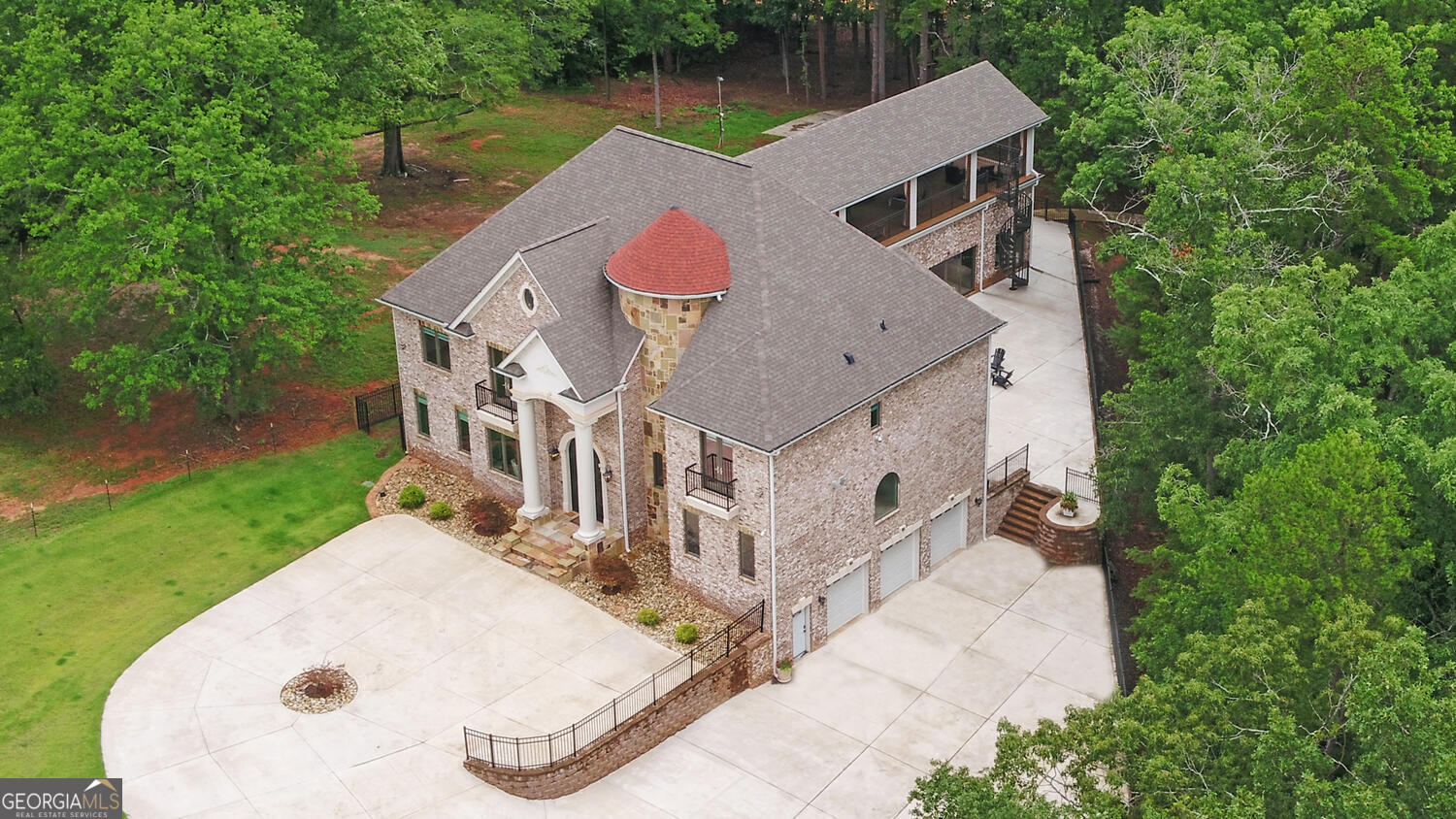 an aerial view of a house with yard