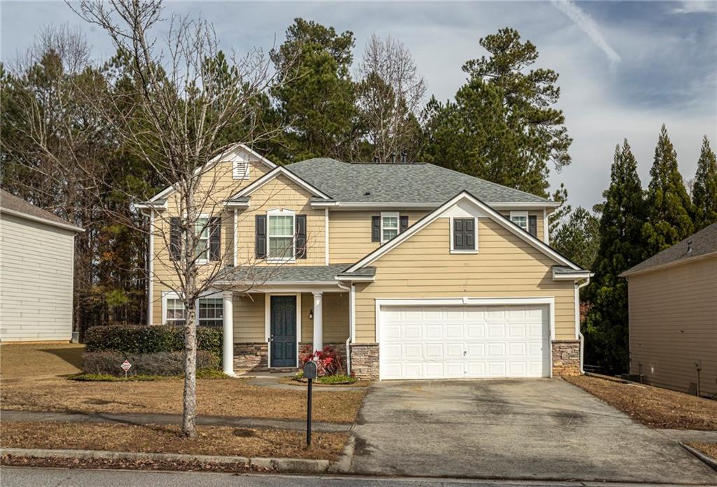 a front view of a house with garage