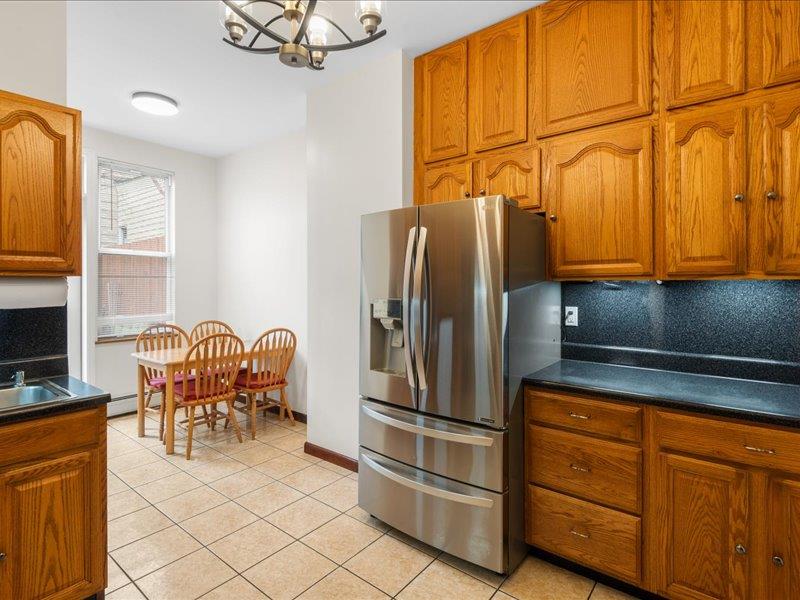 a kitchen with stainless steel appliances granite countertop a refrigerator and a stove top oven