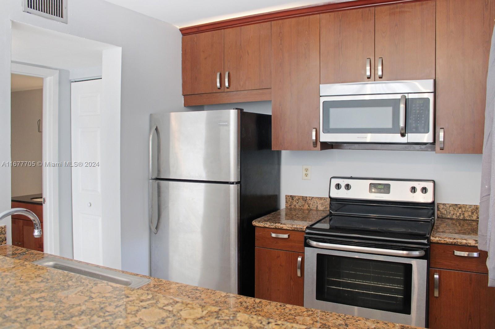 a kitchen with a refrigerator stove and microwave