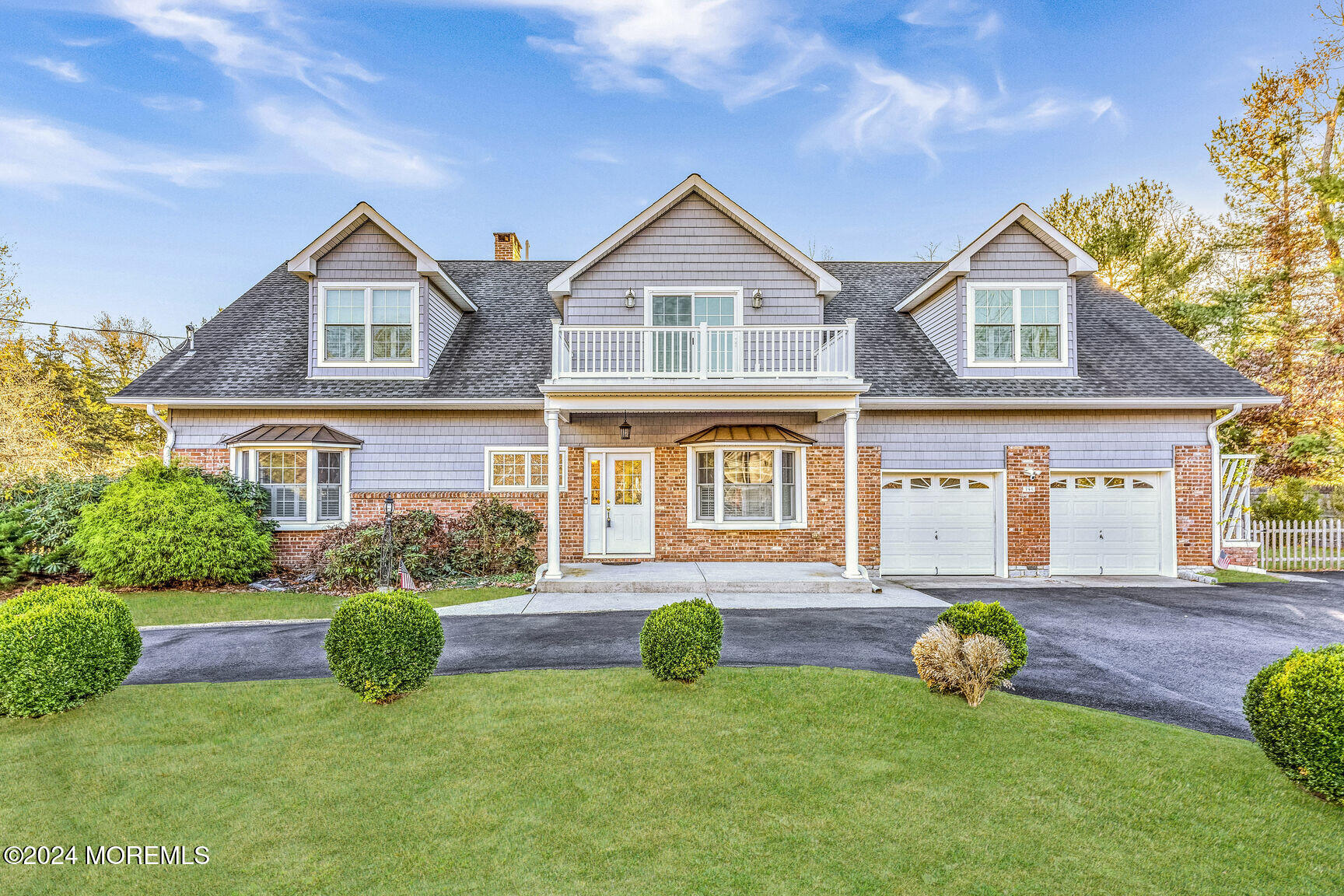 a front view of a house with yard and green space