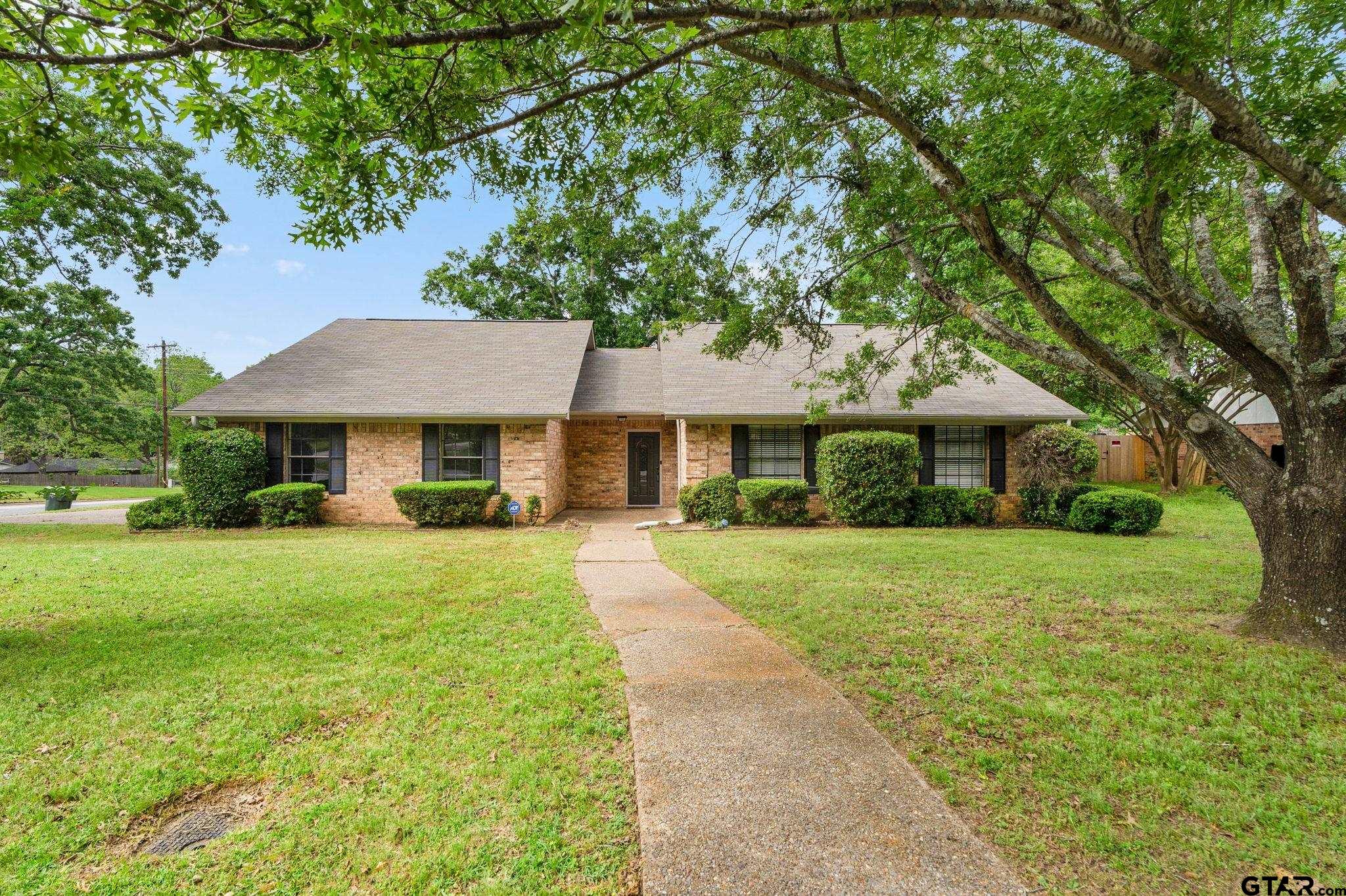 a front view of a house with yard porch and green space