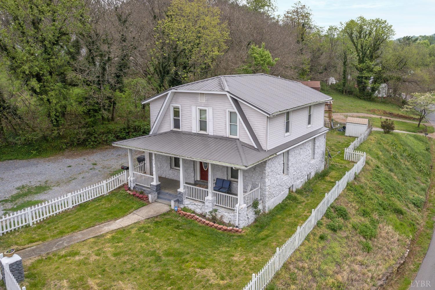 an aerial view of a house with a big yard