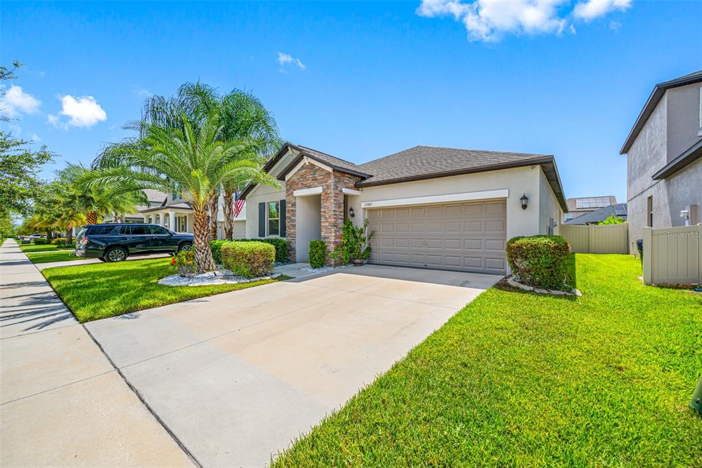 a front view of a house with a yard and garage