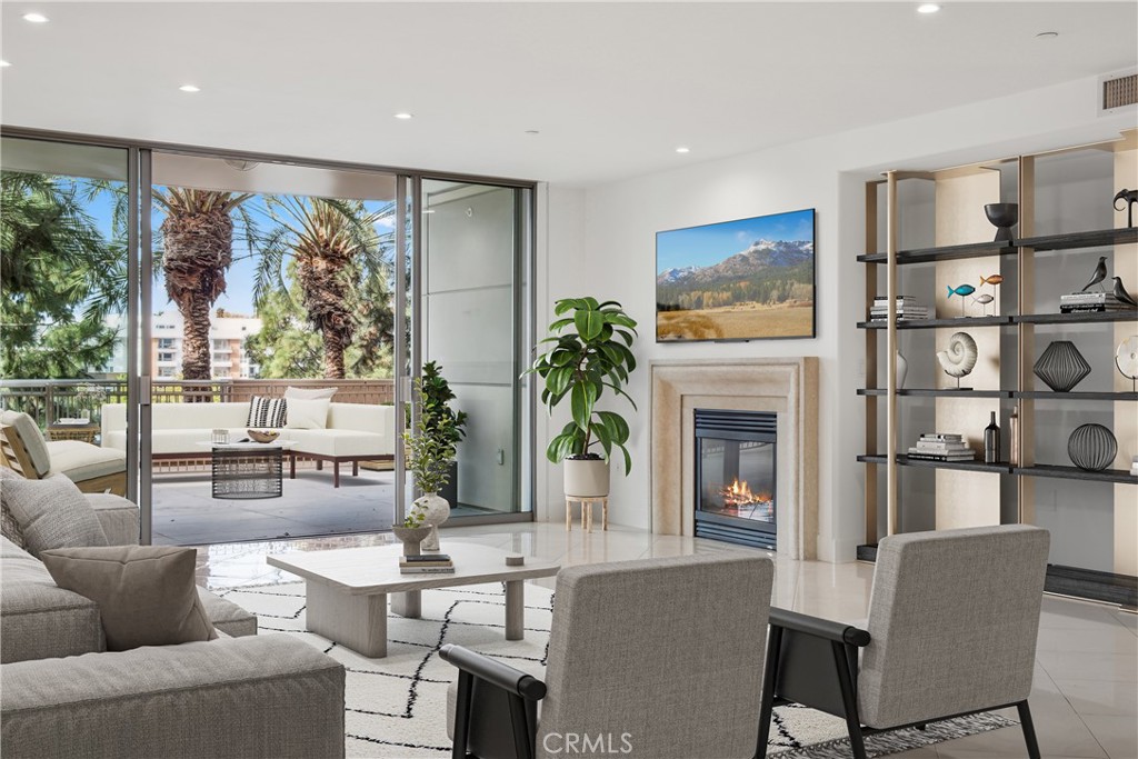 a living room with furniture a fireplace and a floor to ceiling window