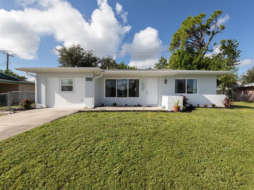 a front view of house with yard and outdoor seating