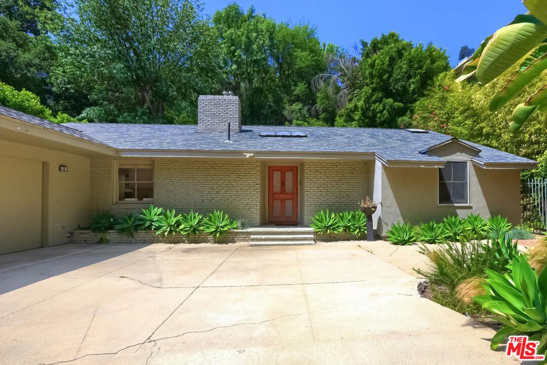 a front view of a house with garden