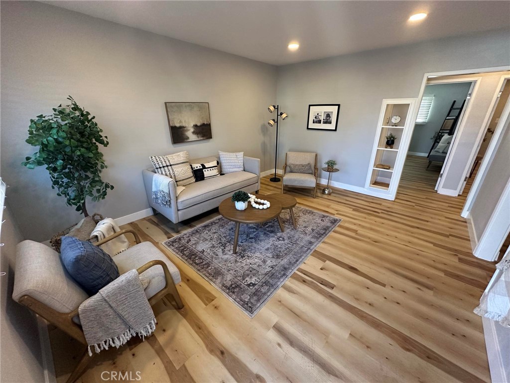 a living room with furniture and wooden floor