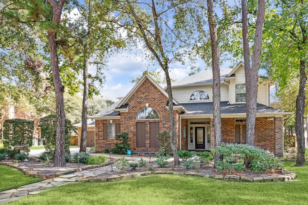 a front view of a house with yard and green space