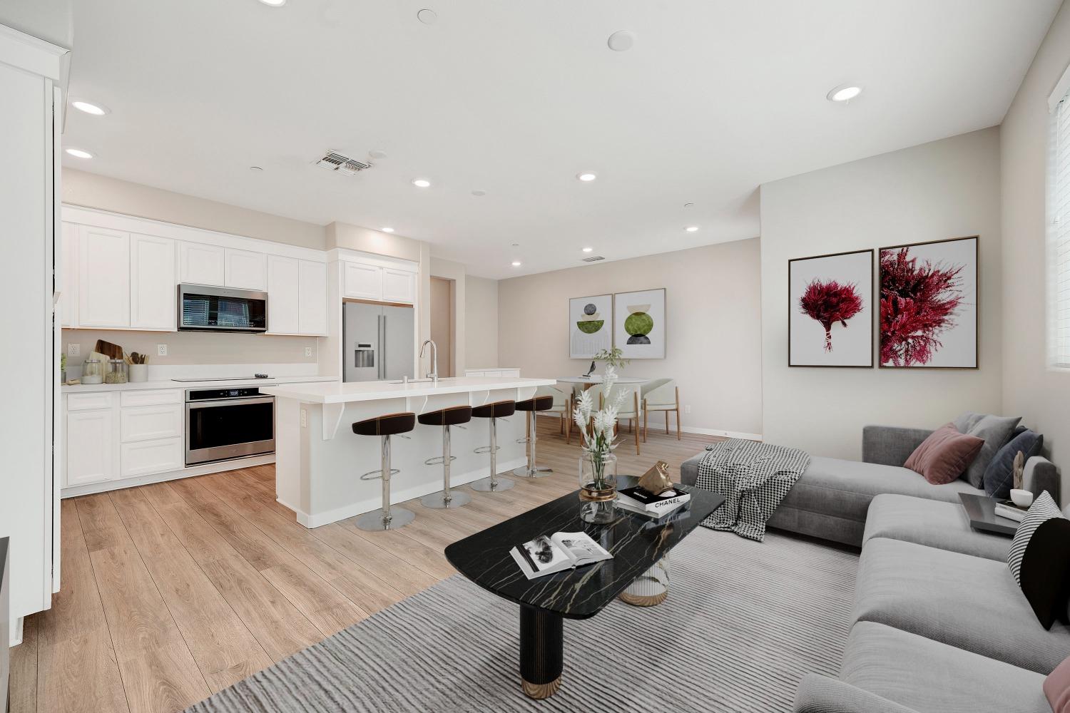 a living room with furniture and kitchen view