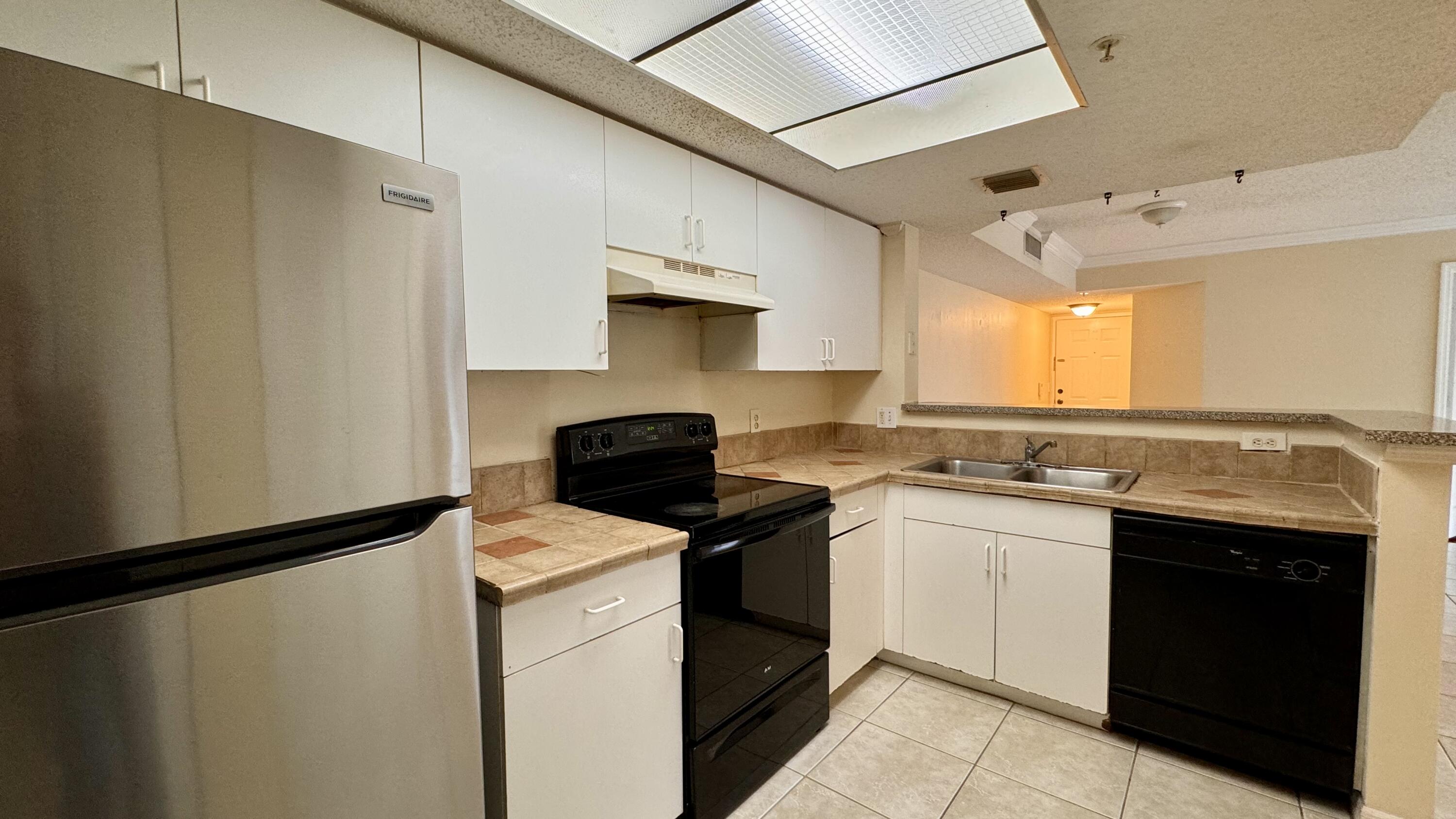 a kitchen with a sink and white cabinets