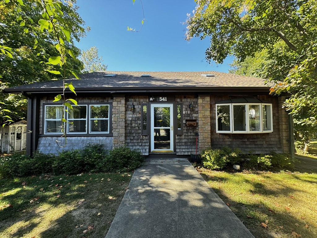 a front view of a house with garden