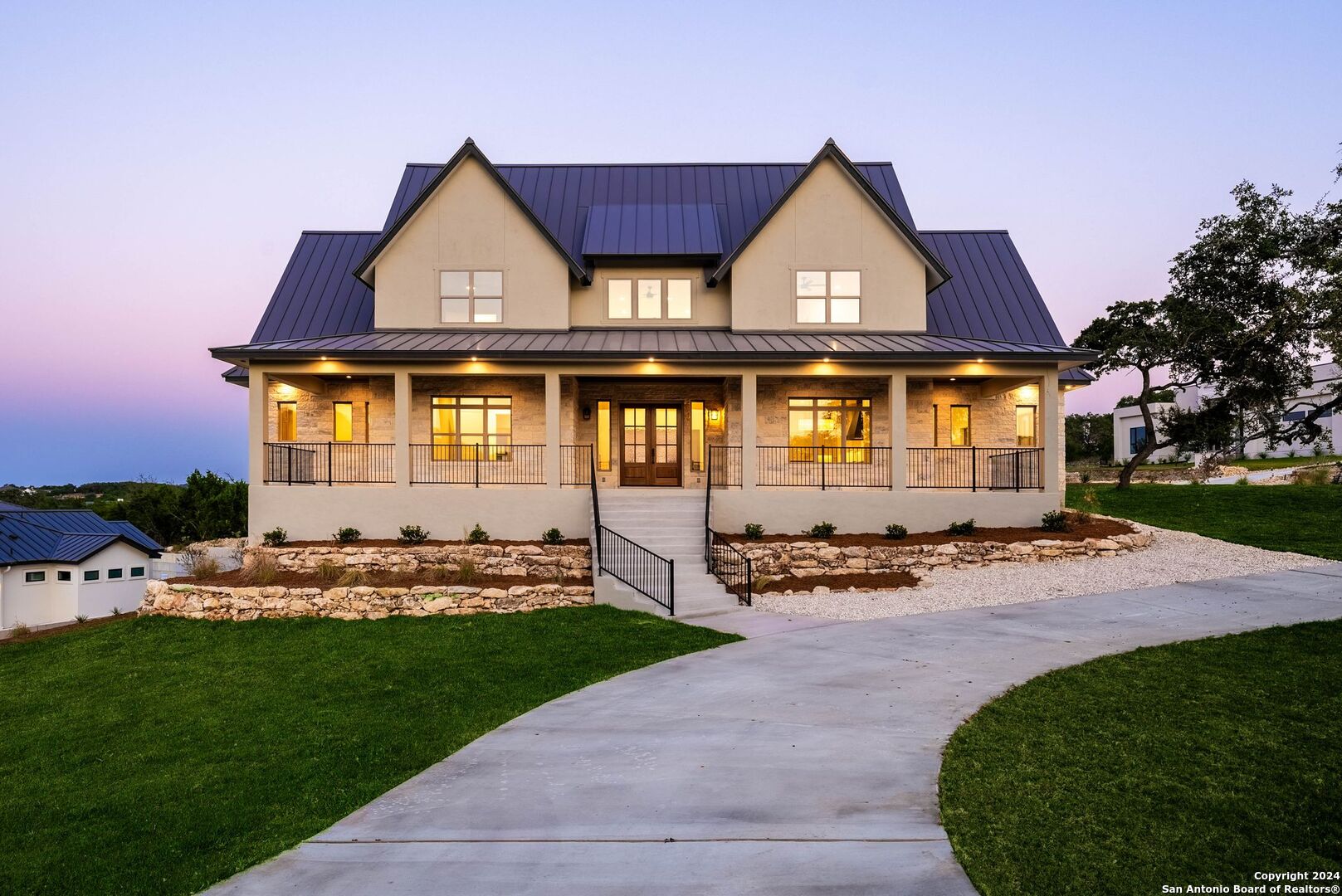 a front view of a house with a garden and yard