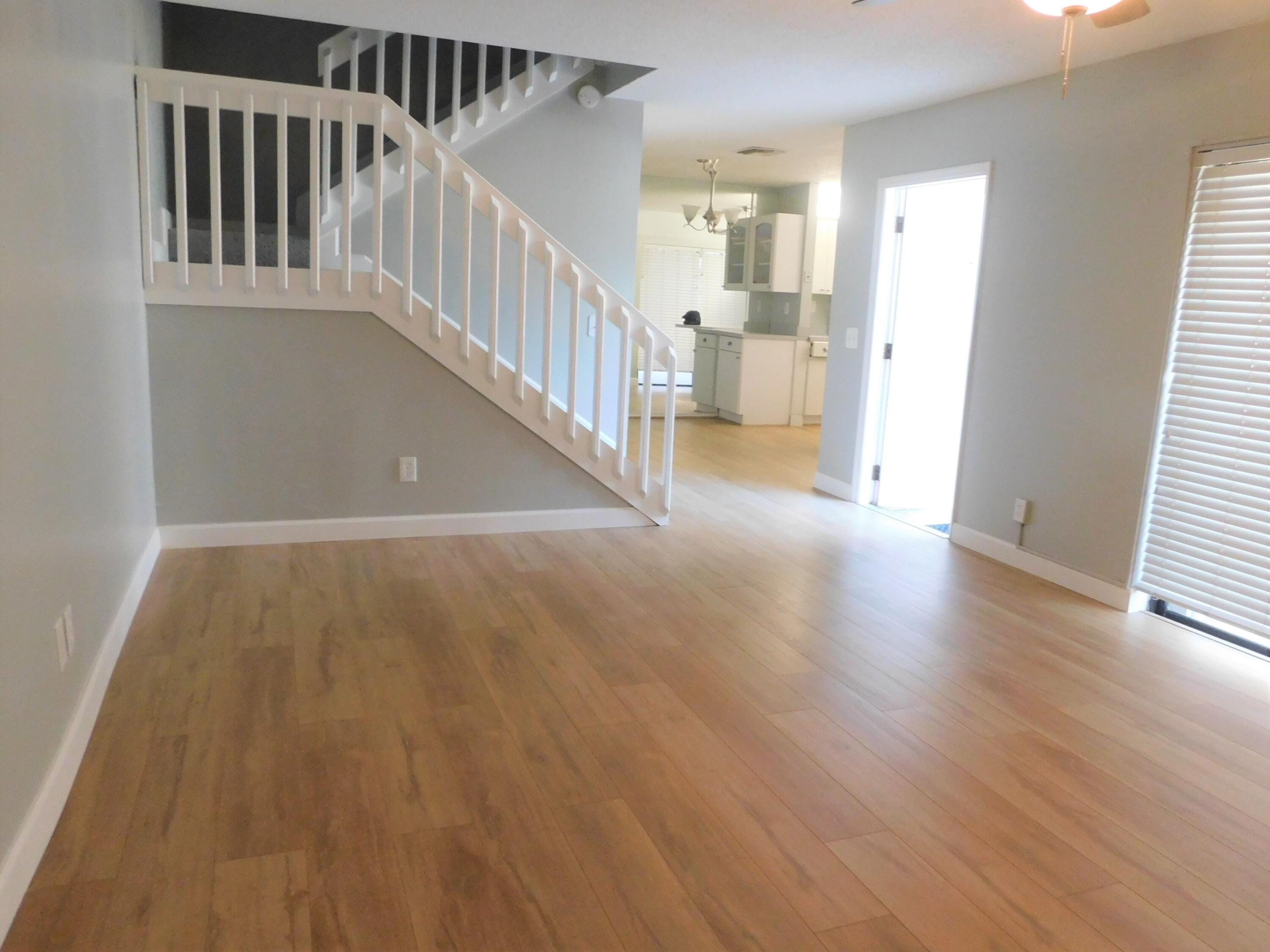 a view of staircase with white walls and a window