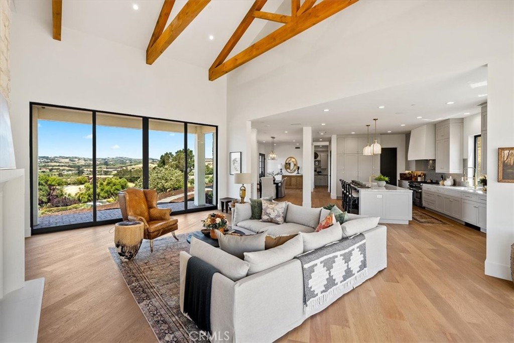 a living room with furniture and large windows