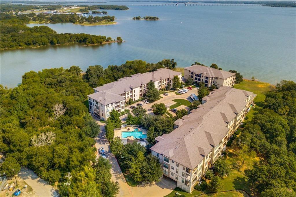 an aerial view of lake and residential houses with outdoor space