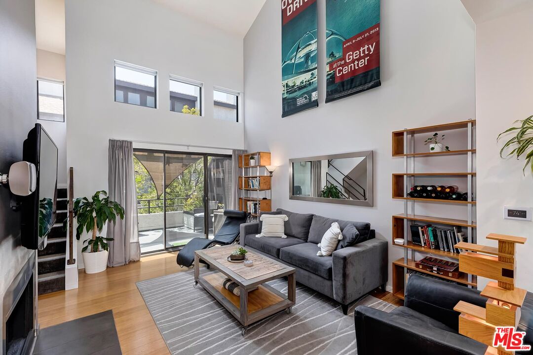 a living room with furniture and a book shelf