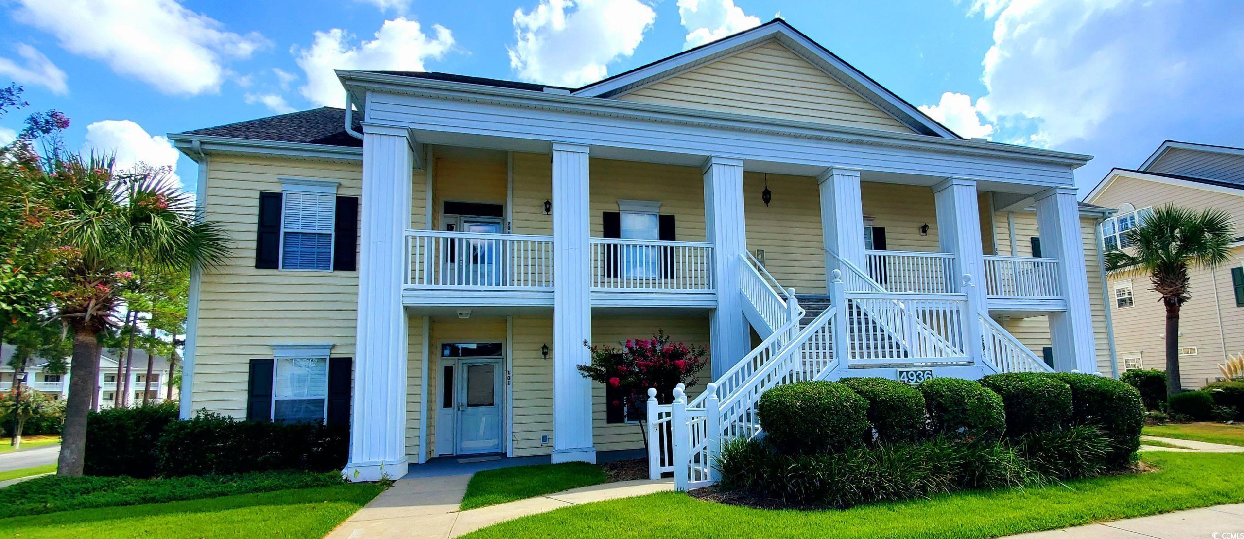 View of front facade featuring a balcony, a front