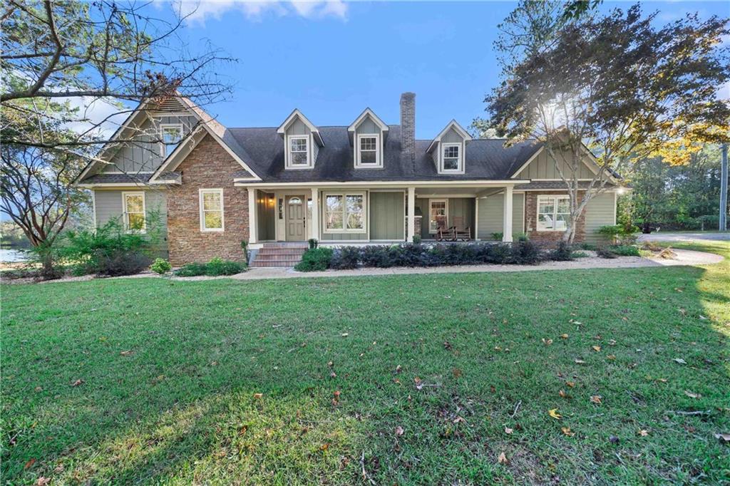 a front view of house with yard and green space