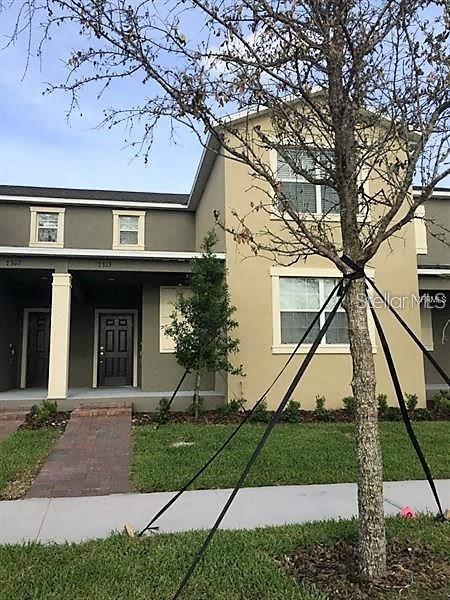 a front view of a house with a yard