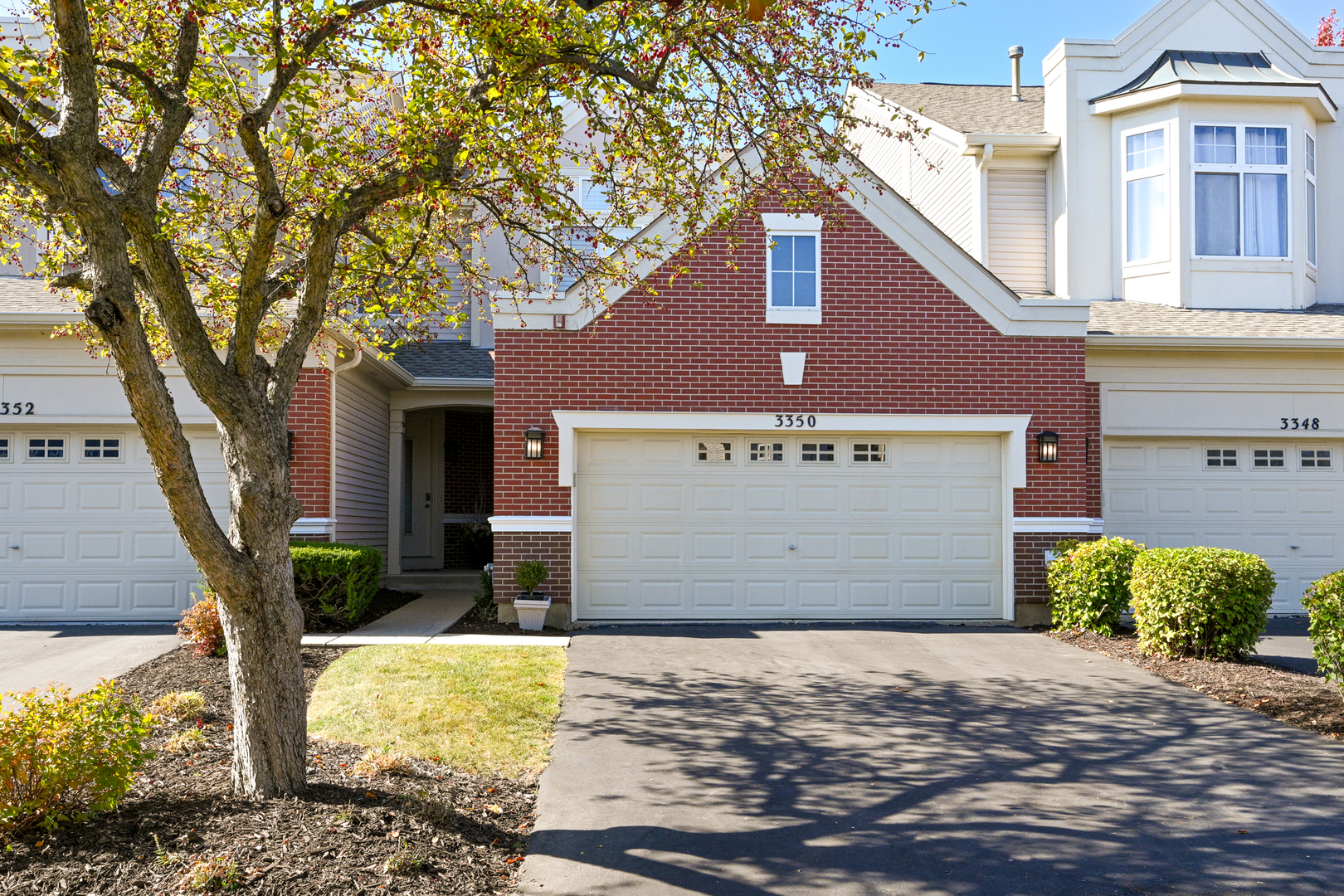 a front view of a building with a yard and garage