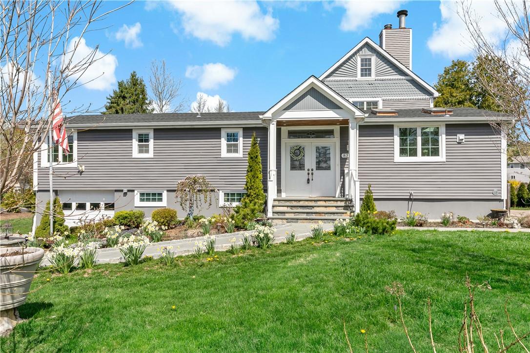 View of front of home featuring a garage and a front yard