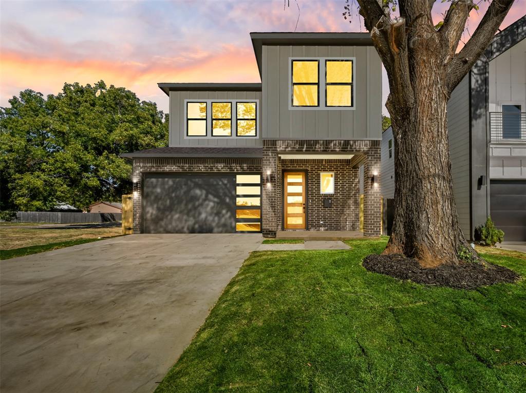 a front view of a house with a yard and garage