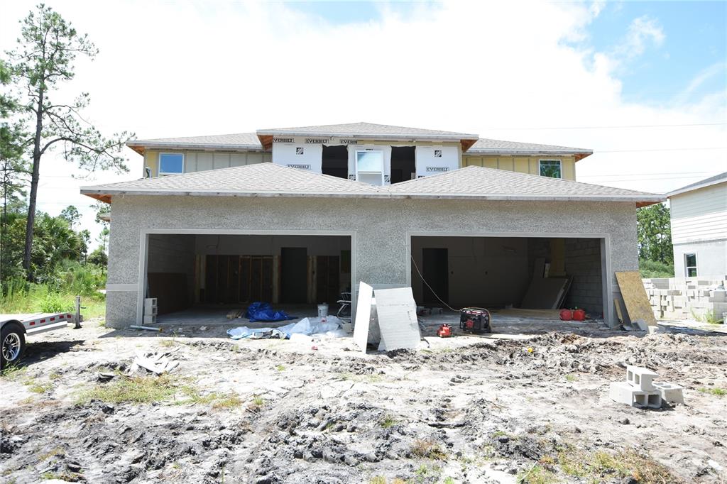 a view of a house with a yard and garage