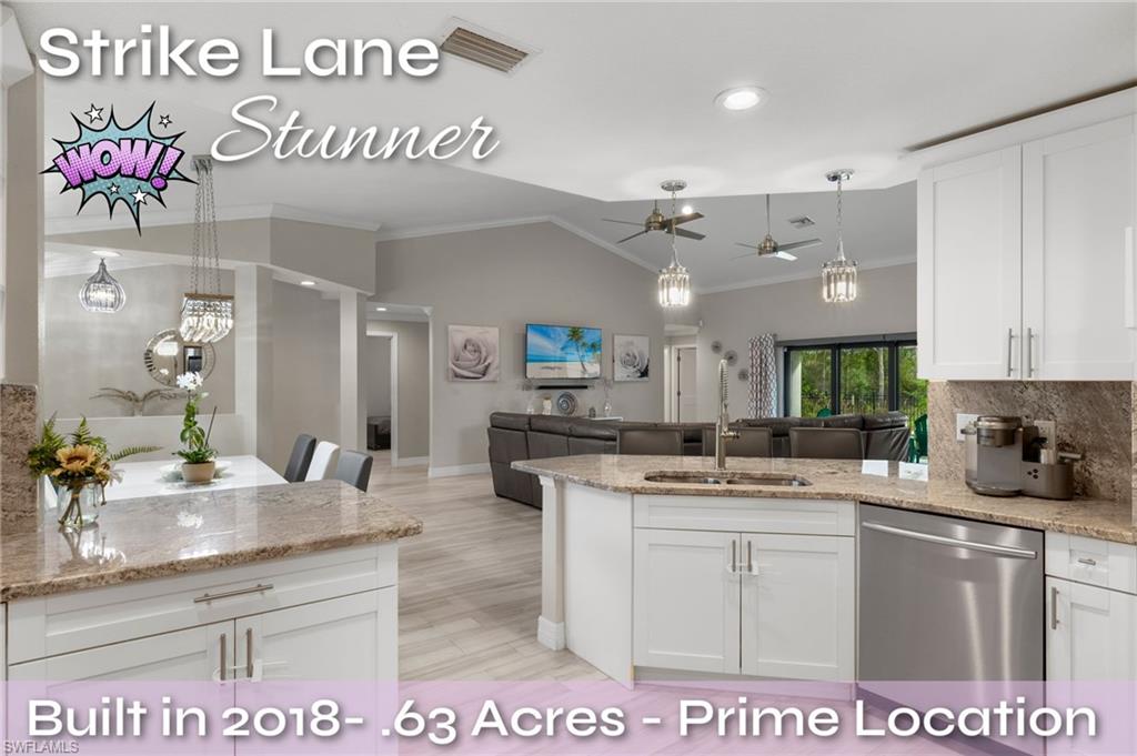 a kitchen with kitchen island granite countertop a sink cabinets and stainless steel appliances