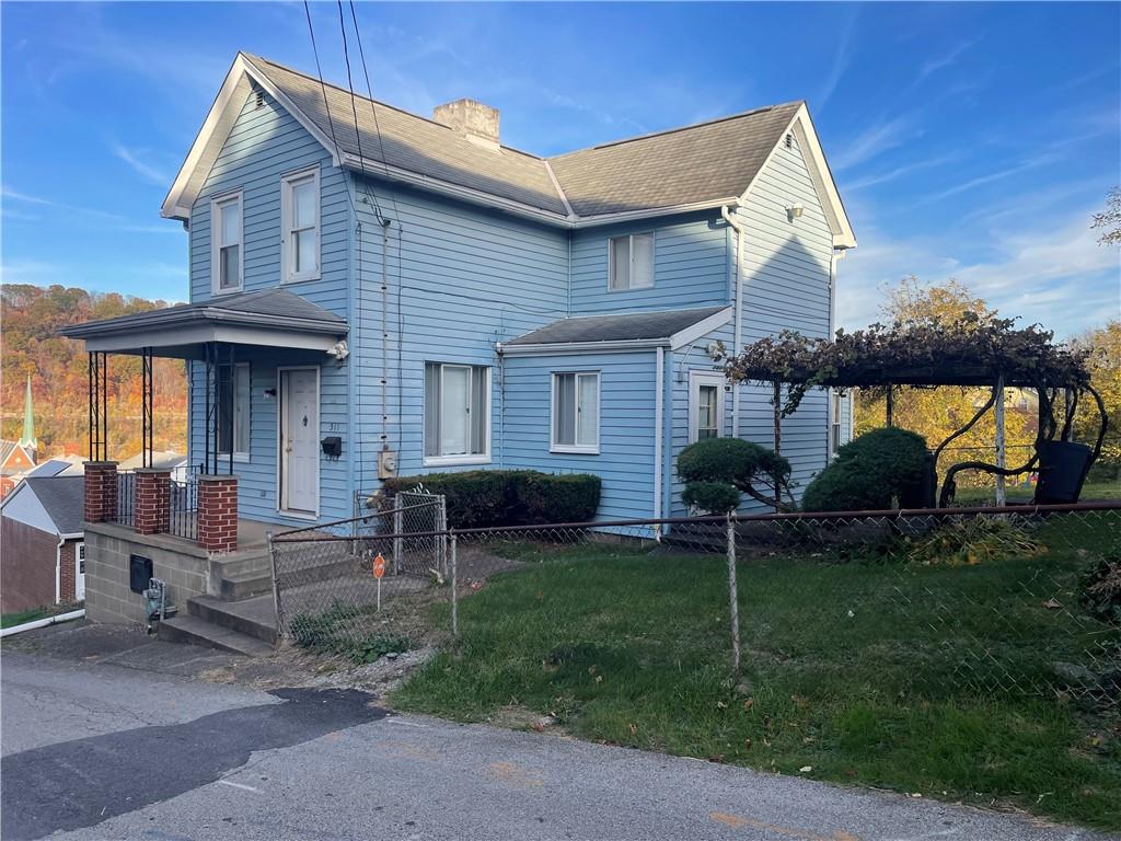 a view of house with a yard