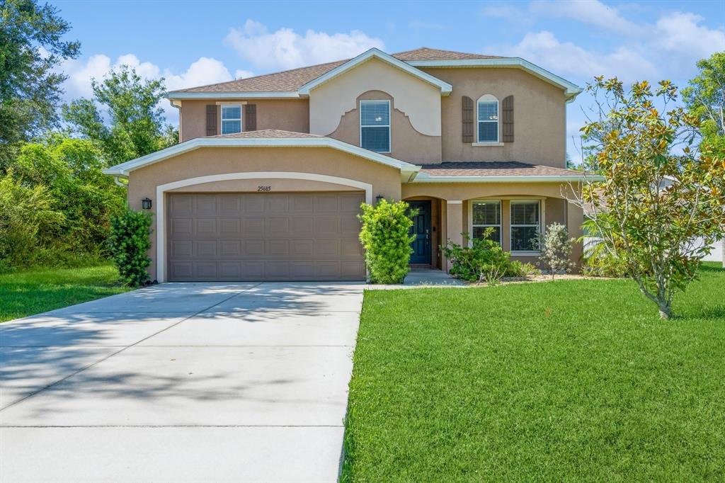 a front view of a house with a yard and garage