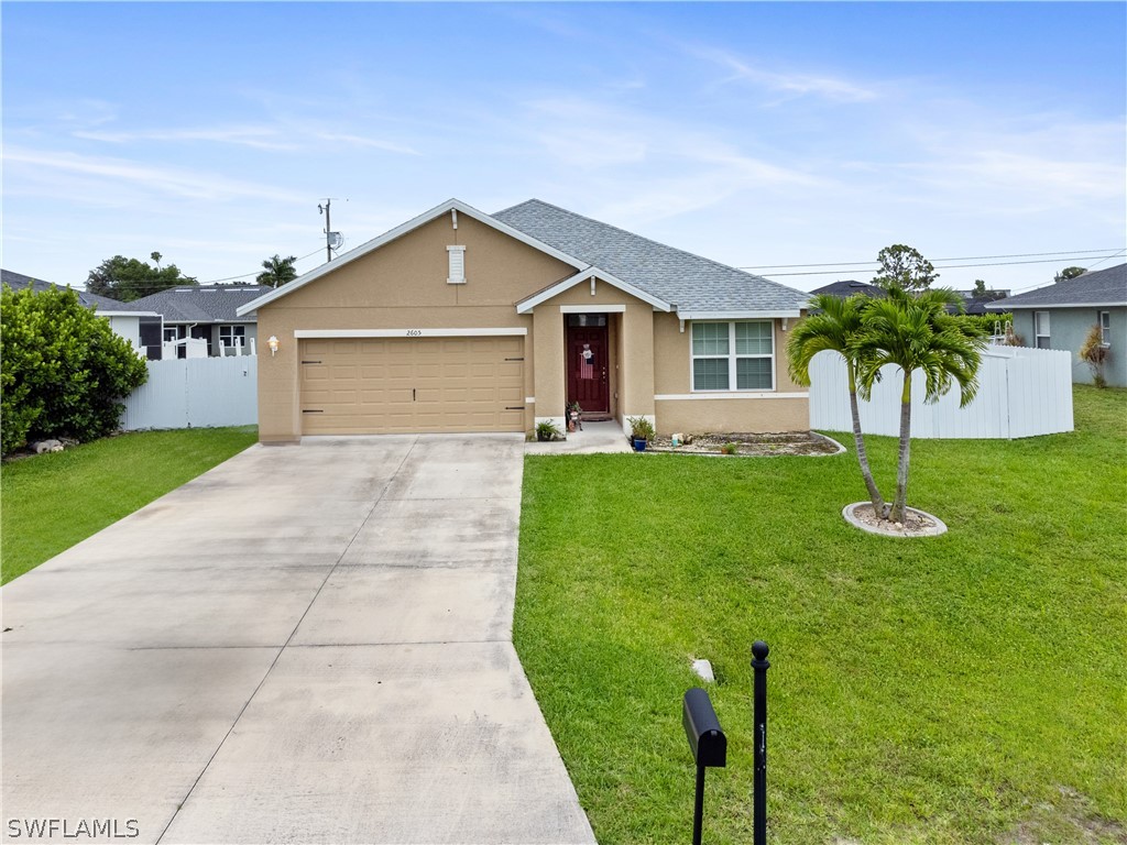 a front view of house with yard and green space