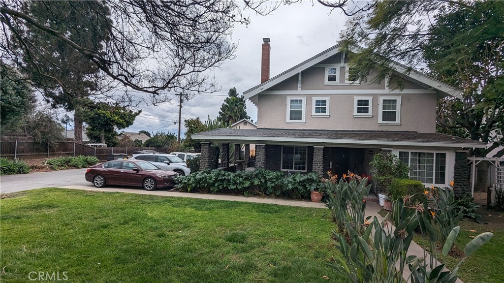 a front view of a house with a garden and plants