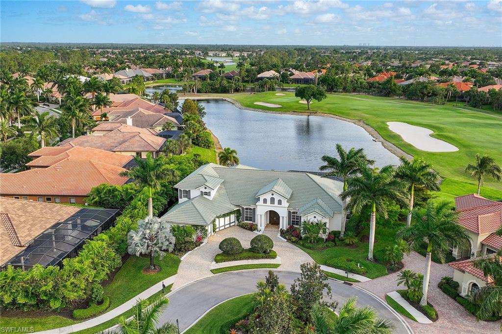 an aerial view of a house with a garden and lake view