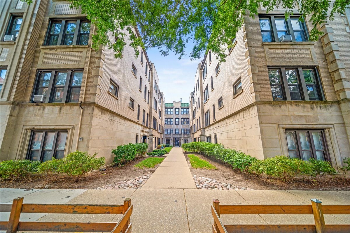 a view of a brick building next to a road