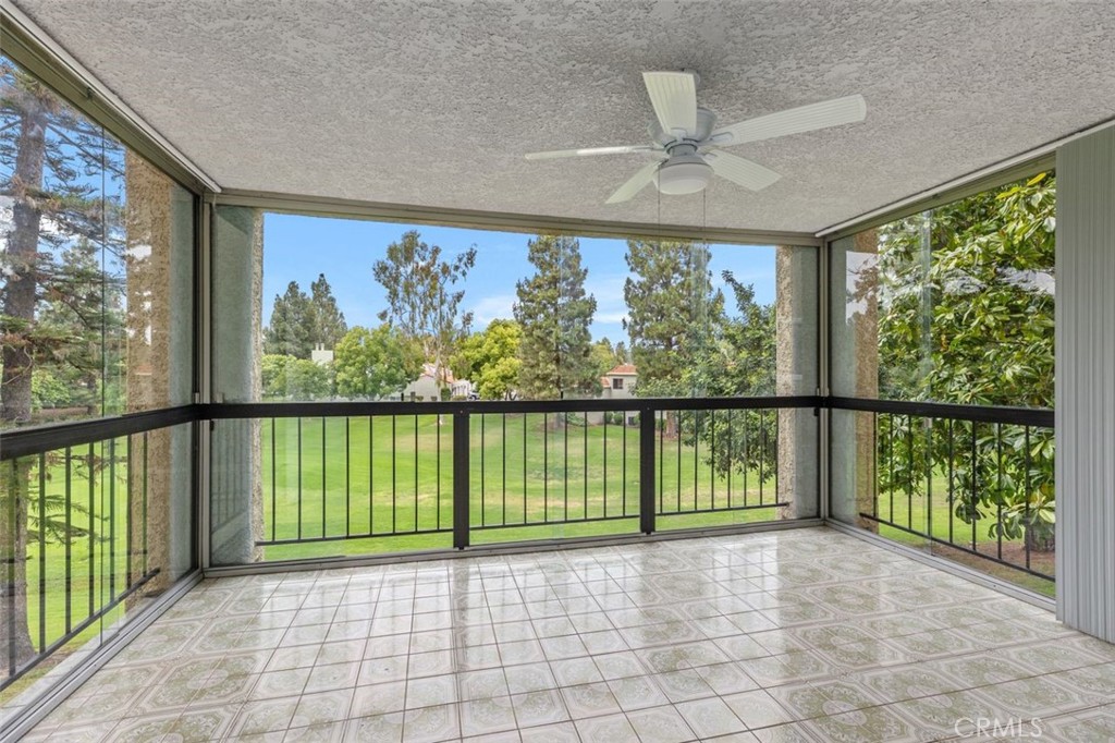 a view of a porch with a floor to ceiling window and a lake view