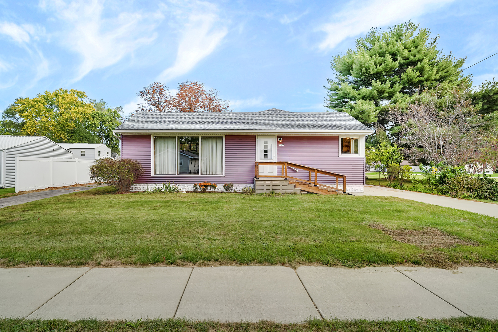 a front view of house with yard and green space