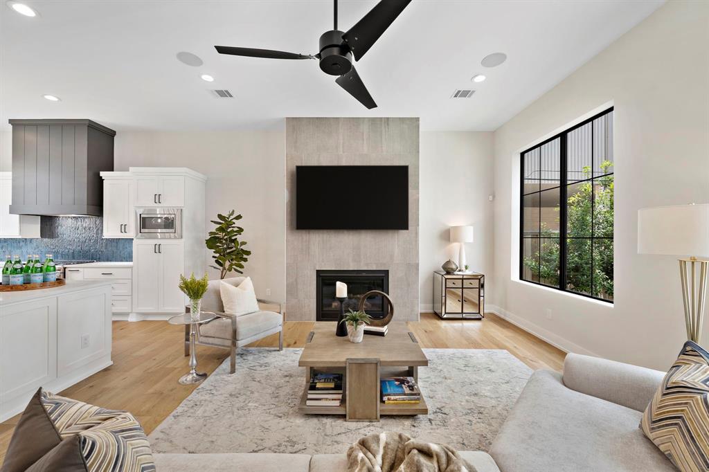 a living room with furniture a fireplace and a flat screen tv