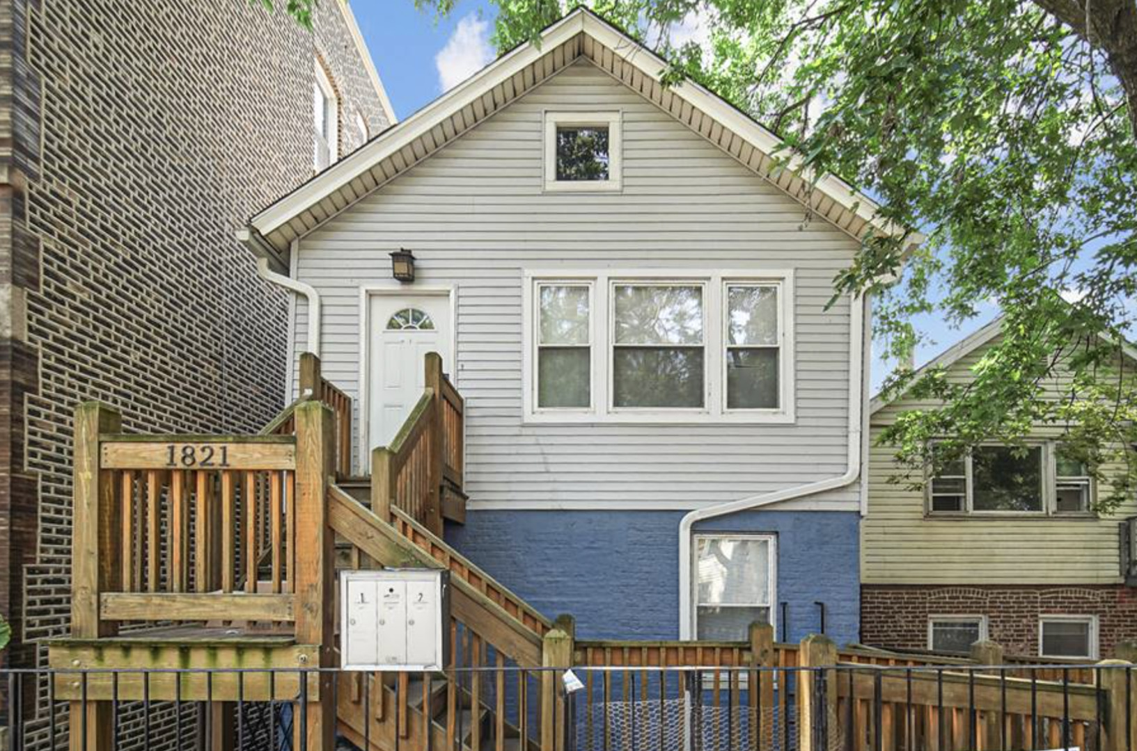 a view of a house with wooden fence