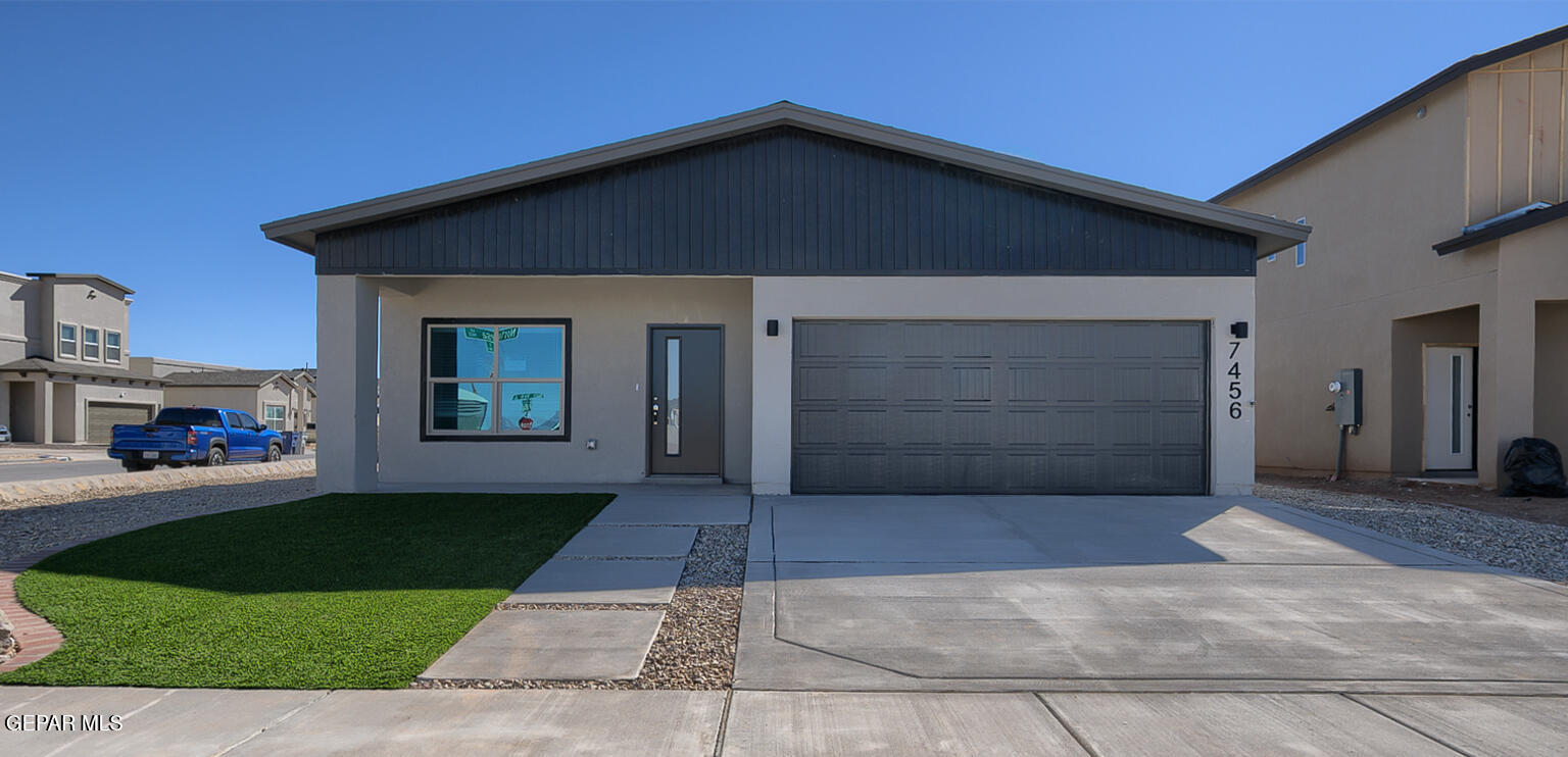 a front view of a house with a yard and garage