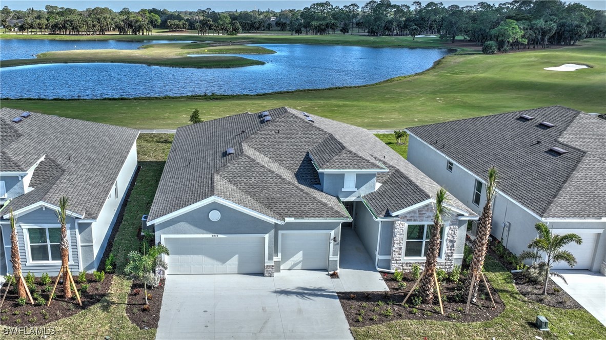 an aerial view of a house with a garden and lake view