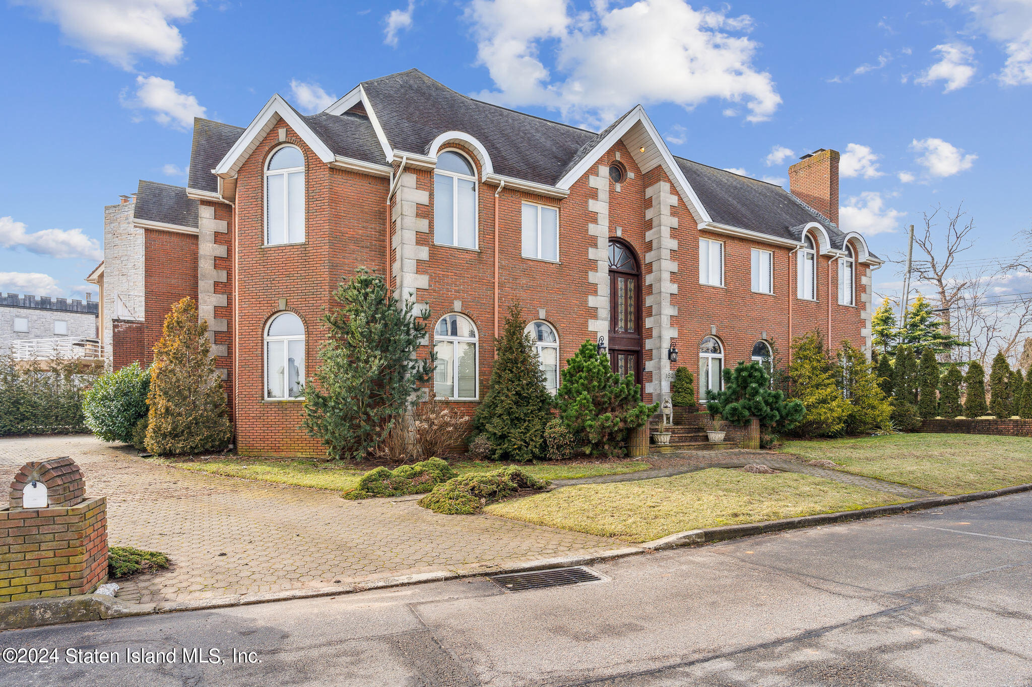 a front view of a residential apartment building with a yard