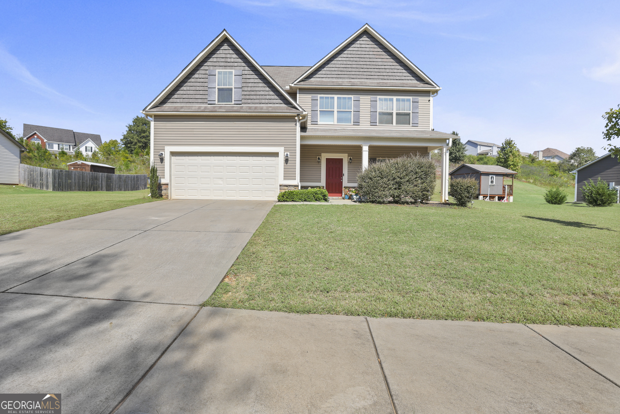 a front view of a house with a yard and garage