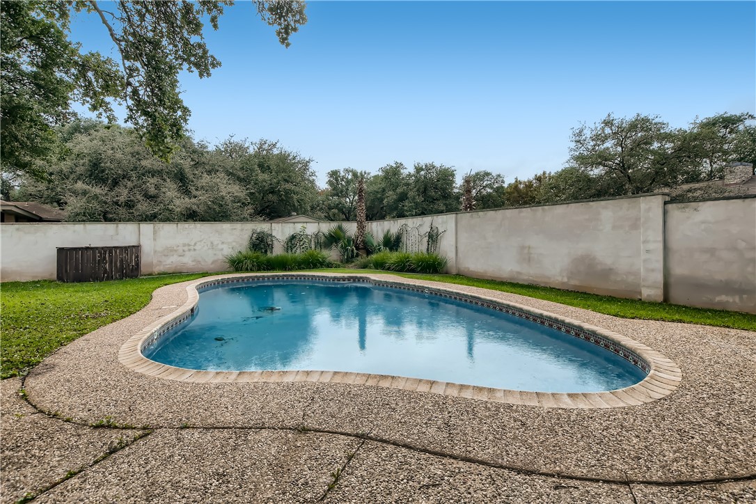 a view of a swimming pool with a yard