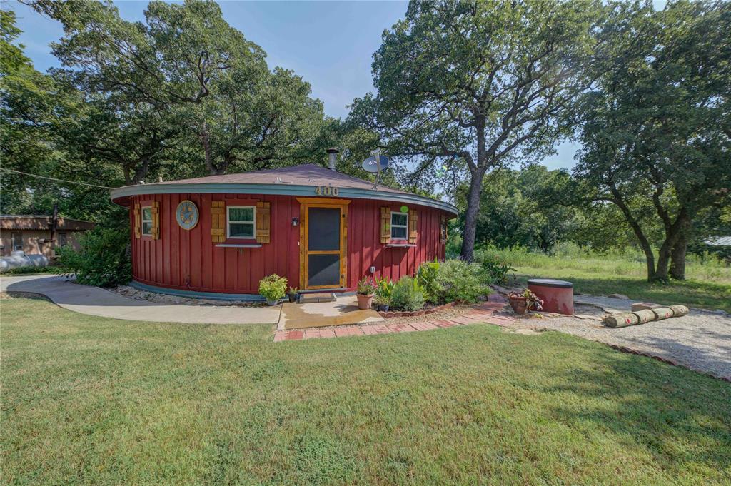 front view of a house with yard and trees