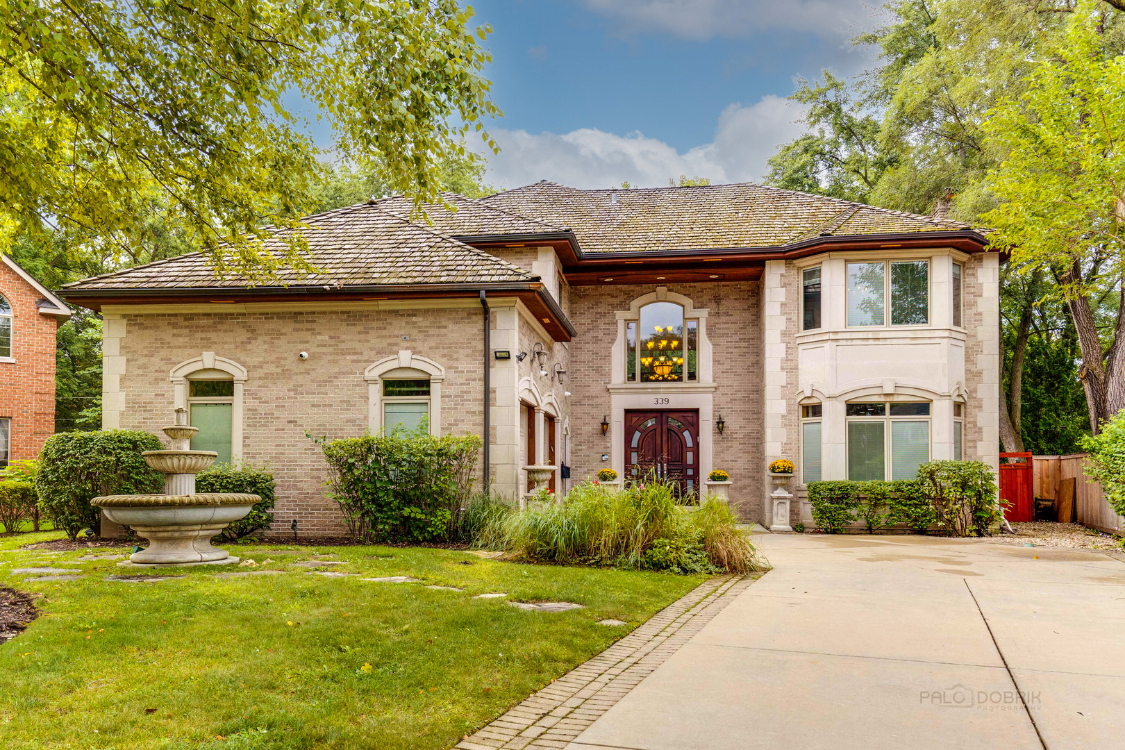 a front view of a house with garden