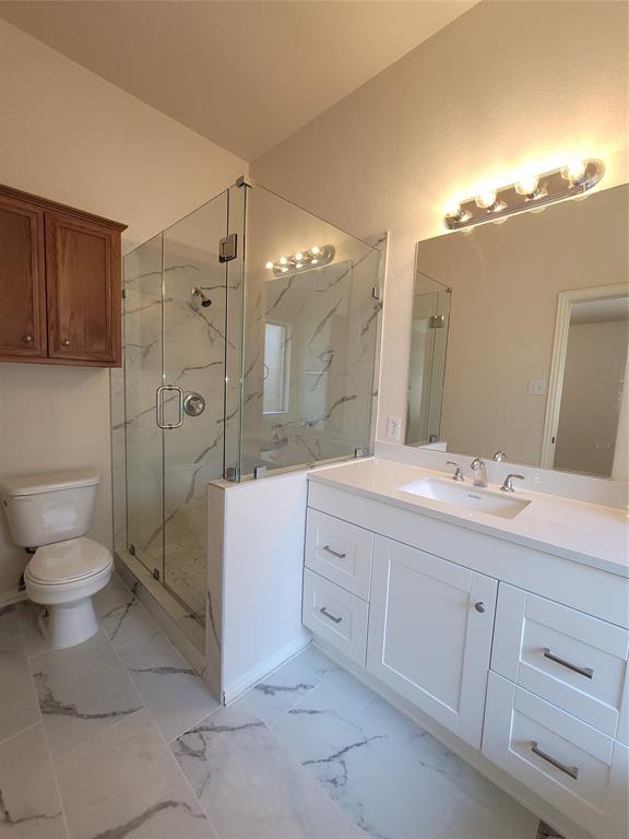 a spacious bathroom with a double vanity sink mirror and toilet