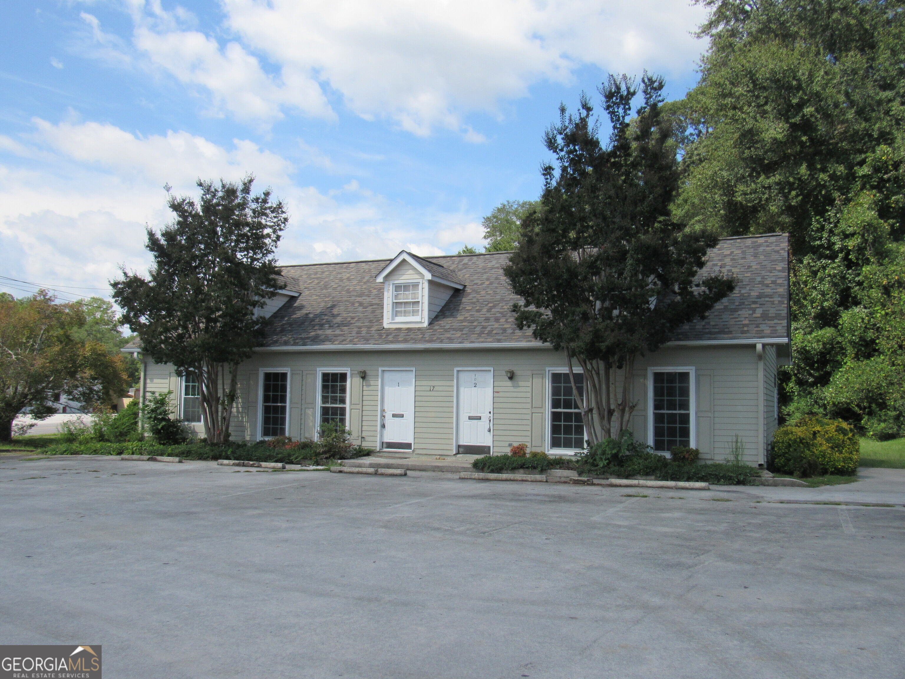 a front view of house with yard and green space