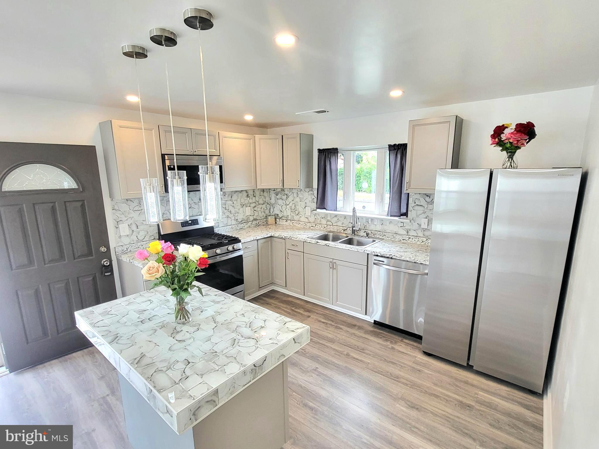 a kitchen with white cabinets and white appliances