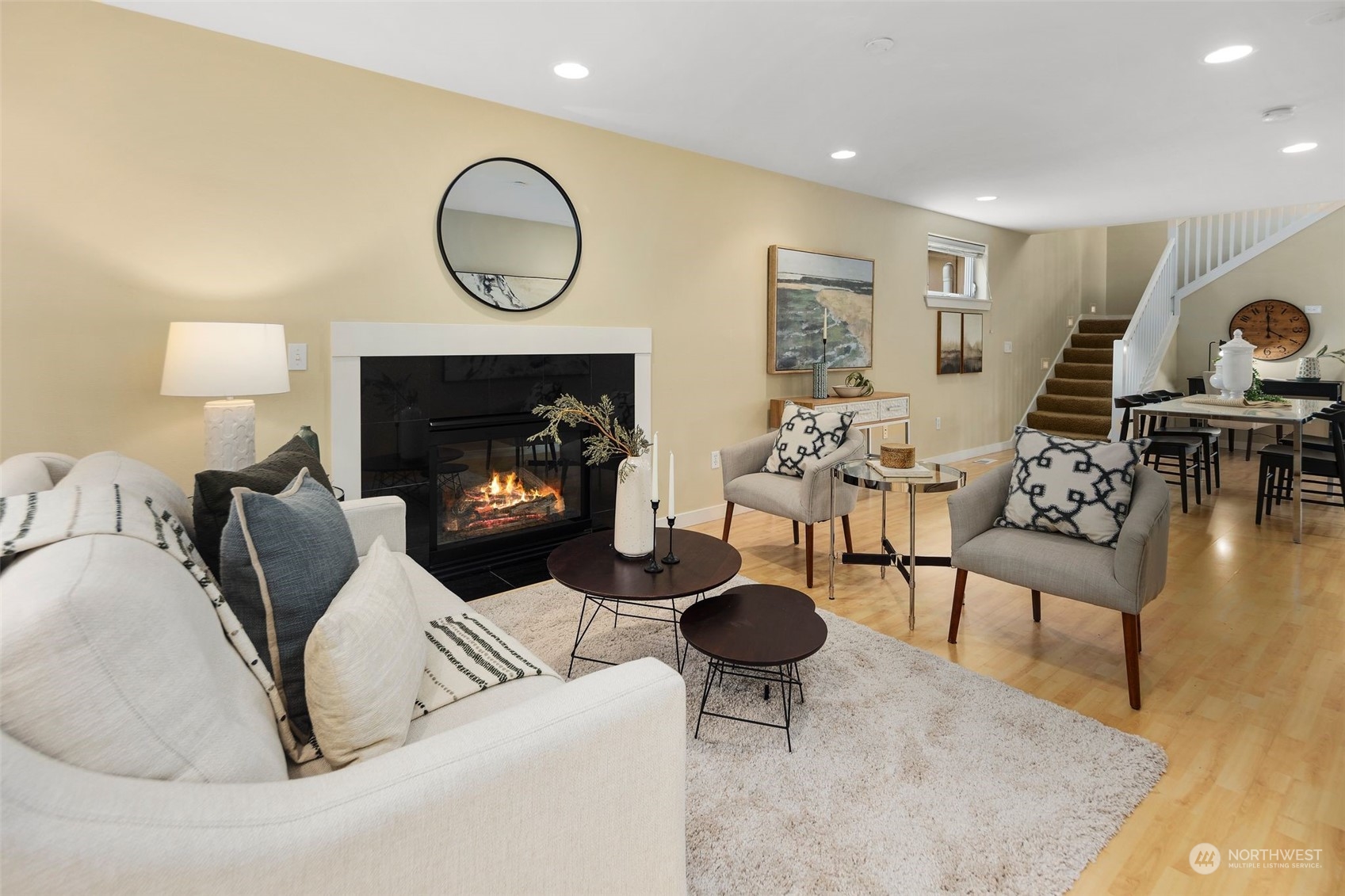 a living room with furniture a fireplace and a table